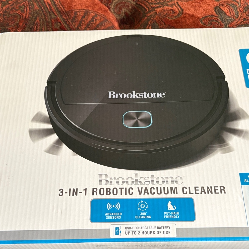 Brookstone Black Robotic Vacuum Cleaner with Teal Accent